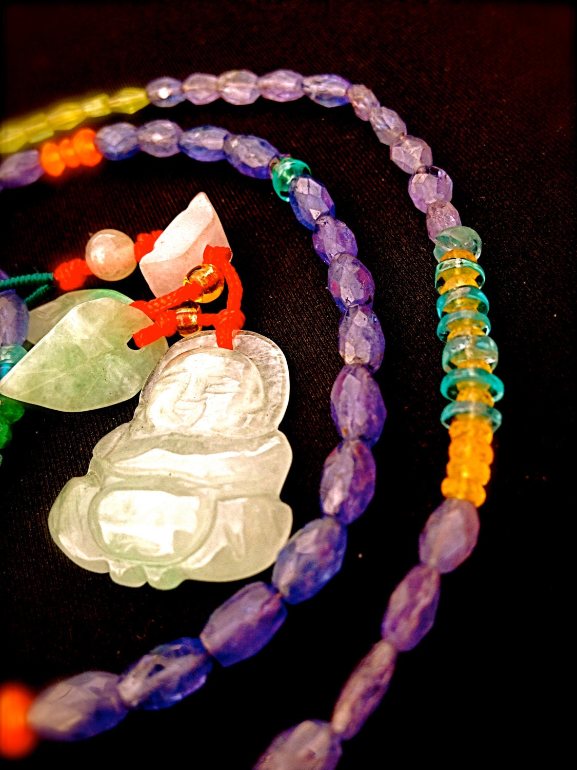 Jade Buddha on a strand of semi-precious stones