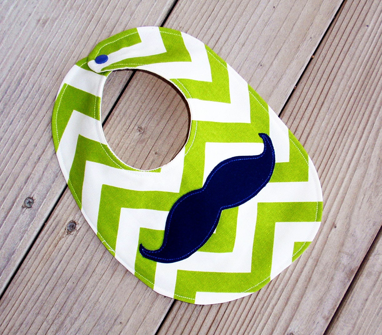 Green and white chevron baby bib with navy mustache
