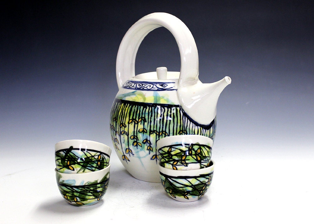 Ceramic and pottery tea set with four matching tea bowls.