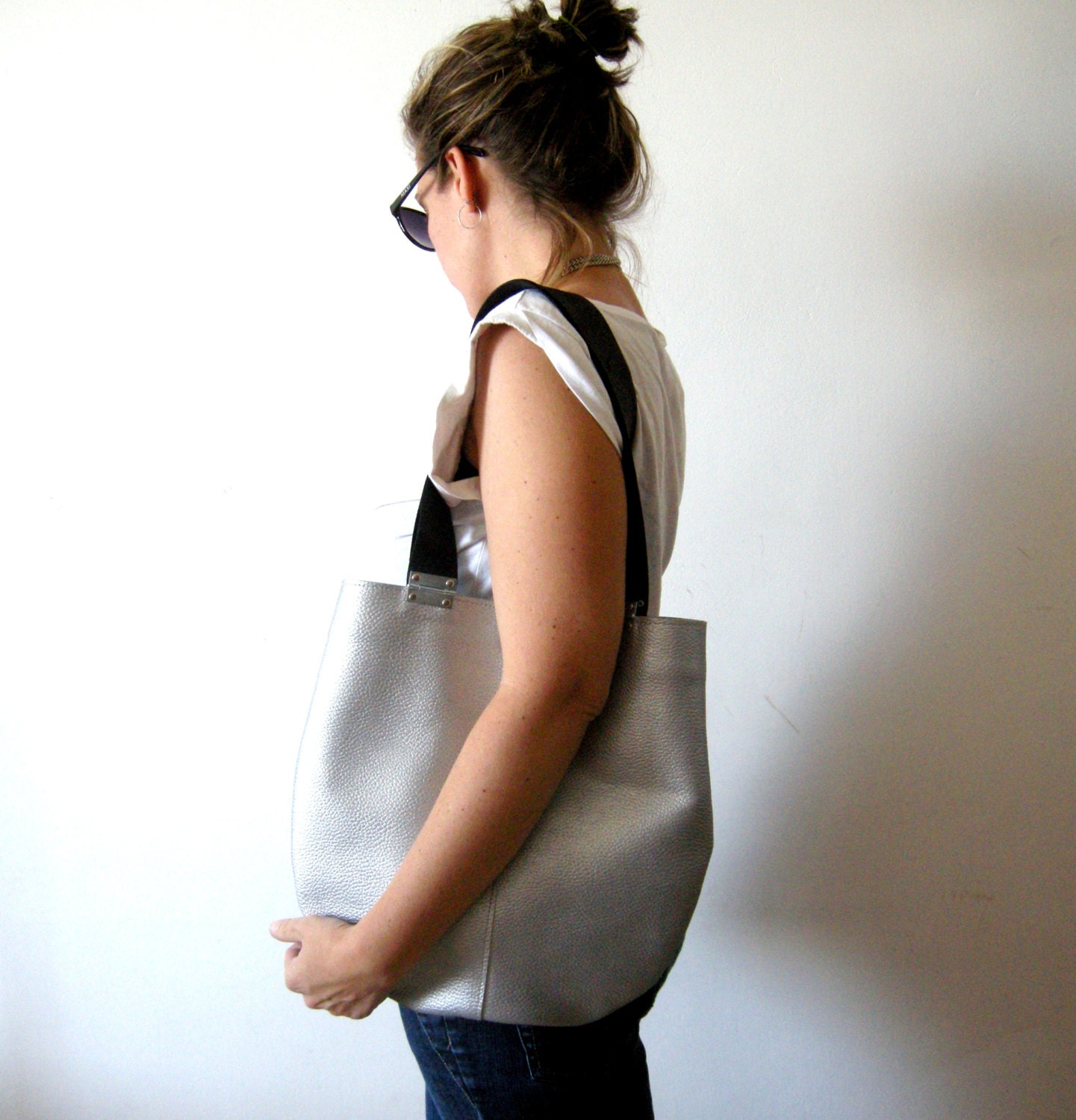 Silver leather bag with black strips and hinges