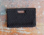 Vintage 1960s black woven clutch with unique snap opening