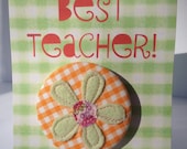 Pretty orange gingham applique flower button badge on BEST TEACHER gift card