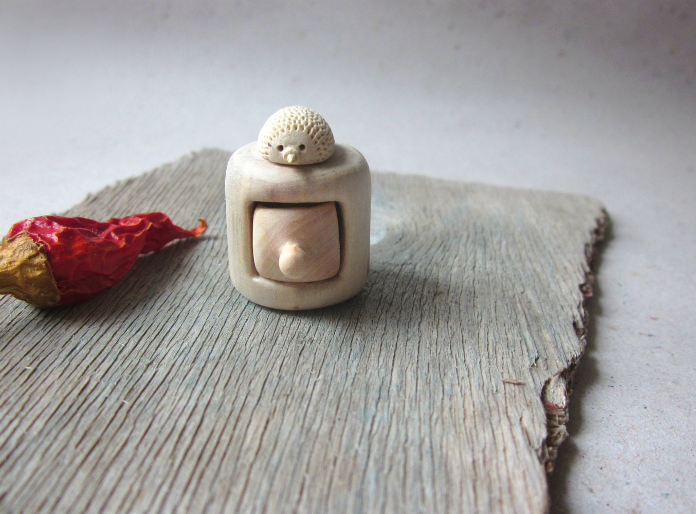 Miniature cabinet with a cute little hedgehog , wood carving