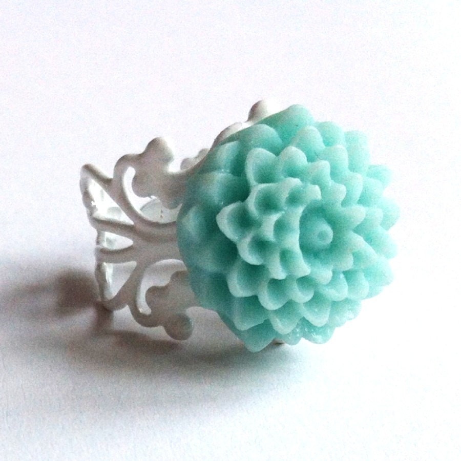 Something Blue Bridal Ring with pale blue Pom flower on a white filigree detail band in an ivory organza gift bag for bride