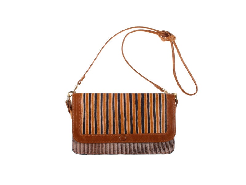 Macaw sling bag in striped printed leather with tan trim and strap