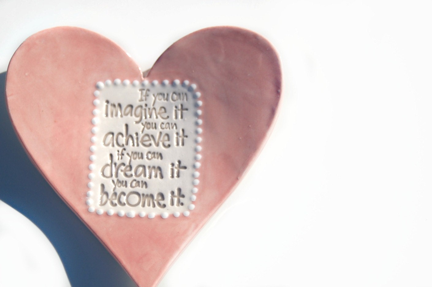 Pink heart tea dish with white dotted detail and quote