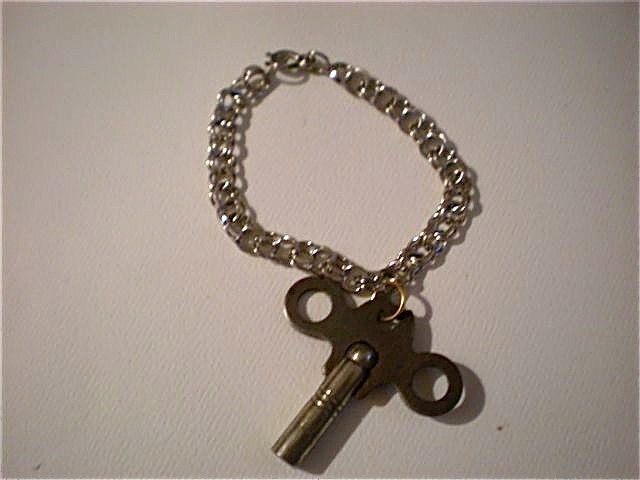 sterling silver charm bracelet with vintage toy key charm attached dont miss