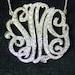 sterling silver monogram , 2" size , with 100cz pave' set.