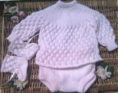 Baby Girl's pink outfit of dress, pants and bootees.