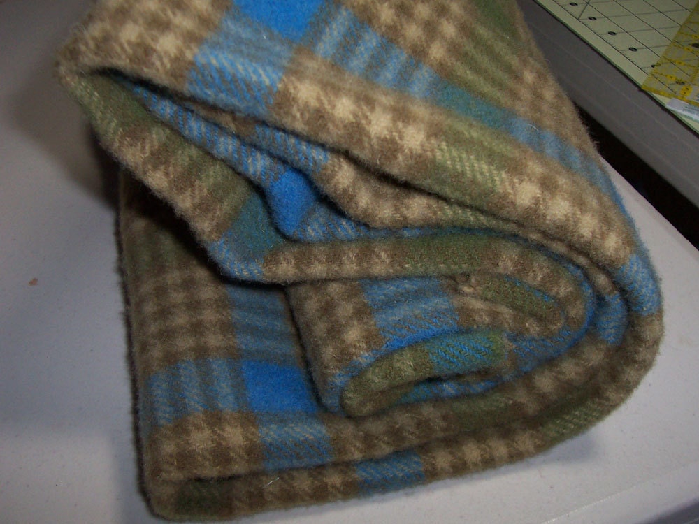Plaid felted wool fabric in blue, green and tan.
