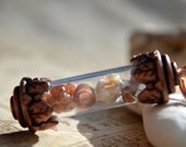 Tiny glass bottle with mini beach finds inside, beach jewelry, copper capped bottle