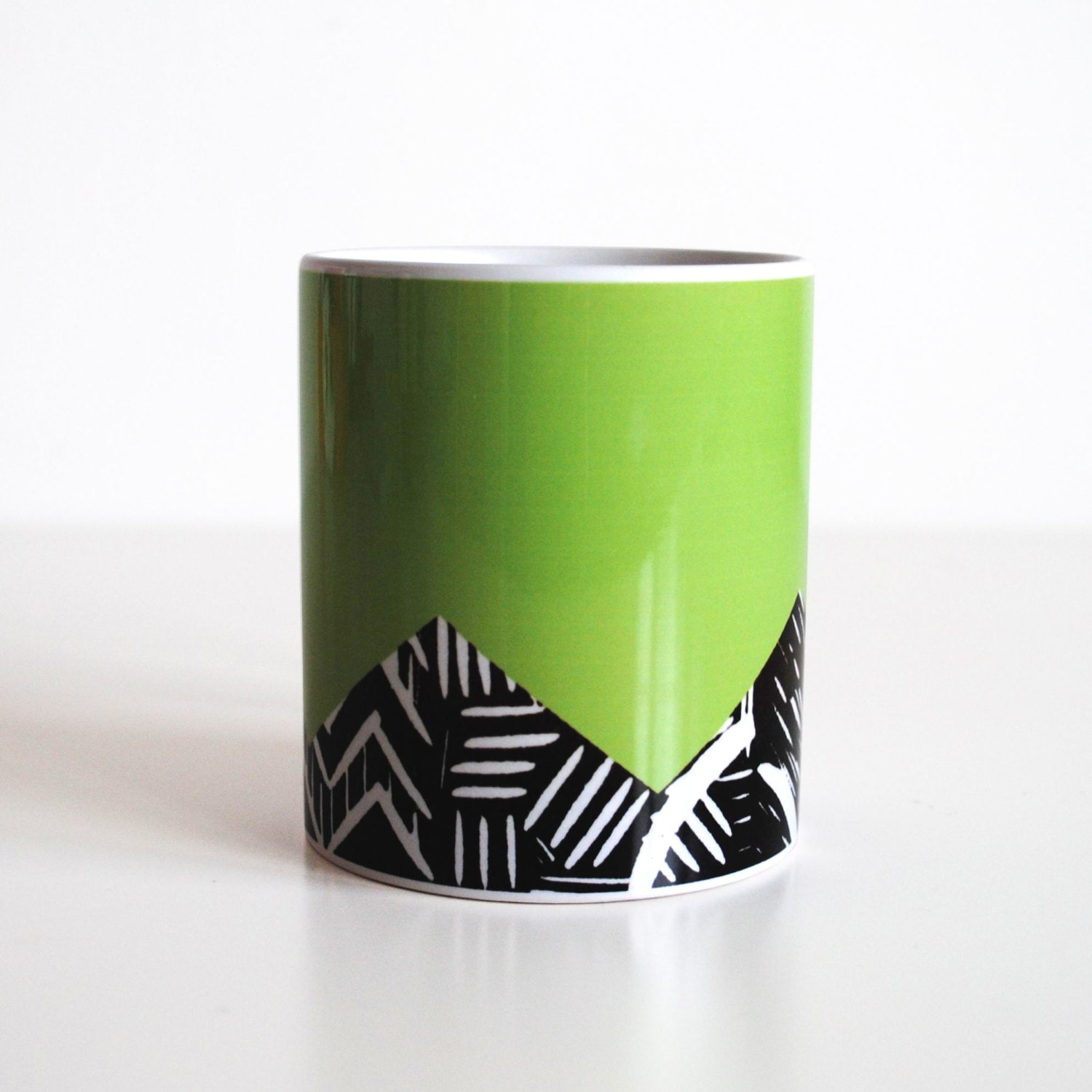 Bright green mug with lino print design