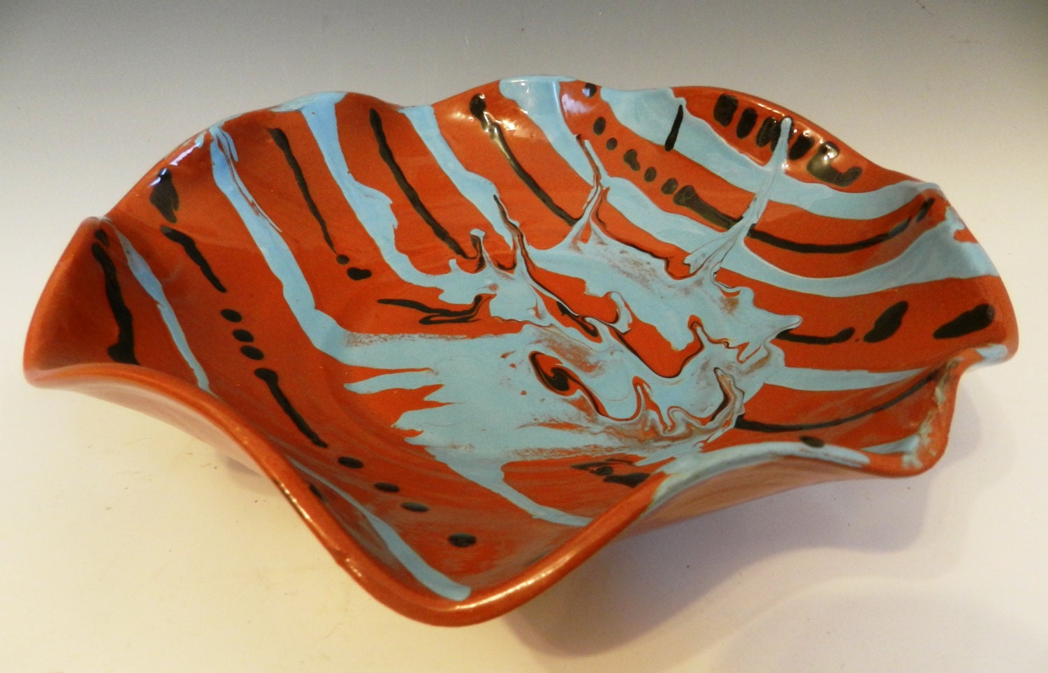 Altered terracotta bowl with slips and mason stains