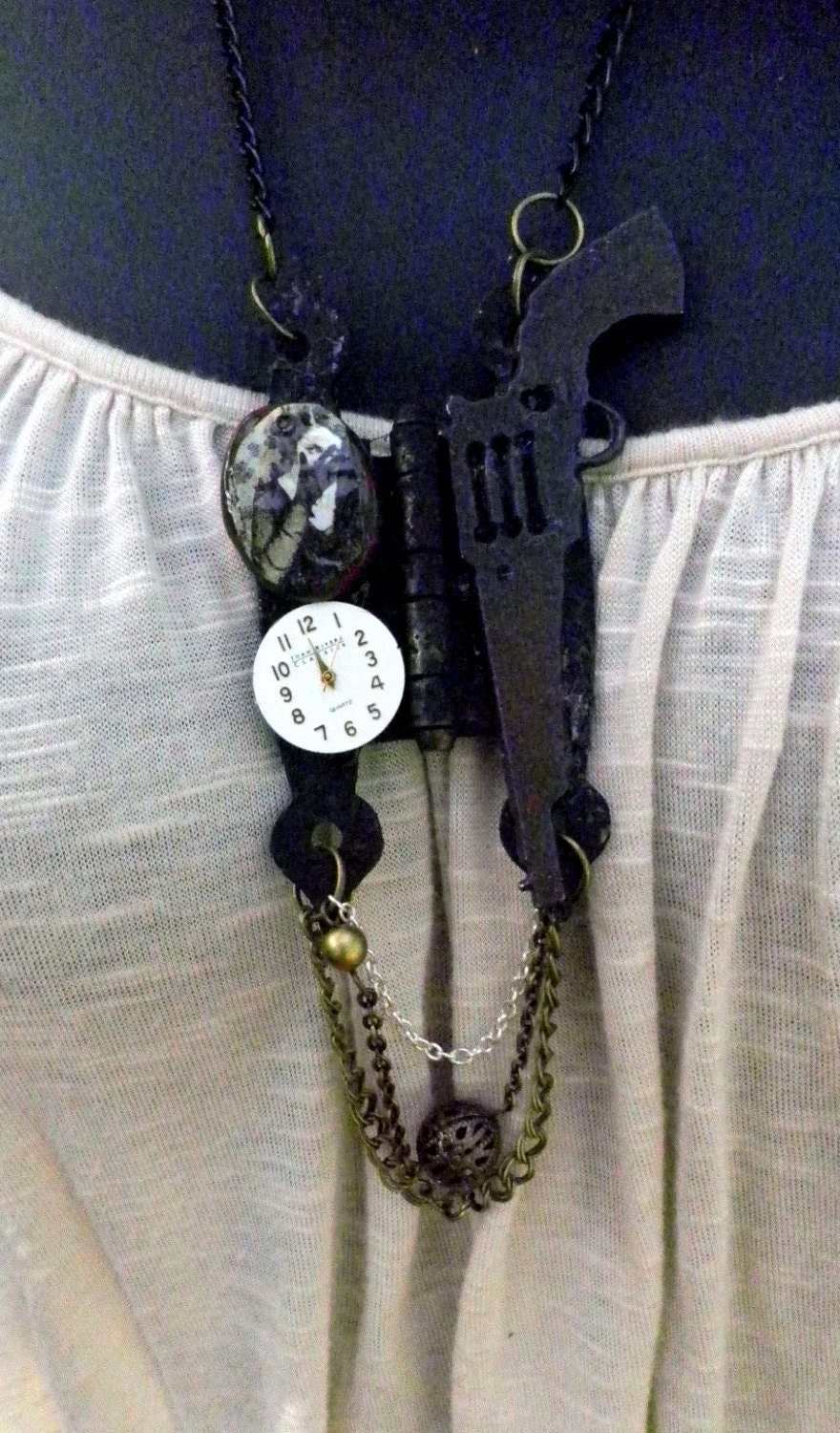 Hardware layered necklace with watchface, rustic gun, and image of french woman