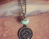 aquarius.  a brass astrological sign trinket necklace.