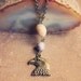 aquila.  a simple earthy polished stone and eagle charm necklace.
