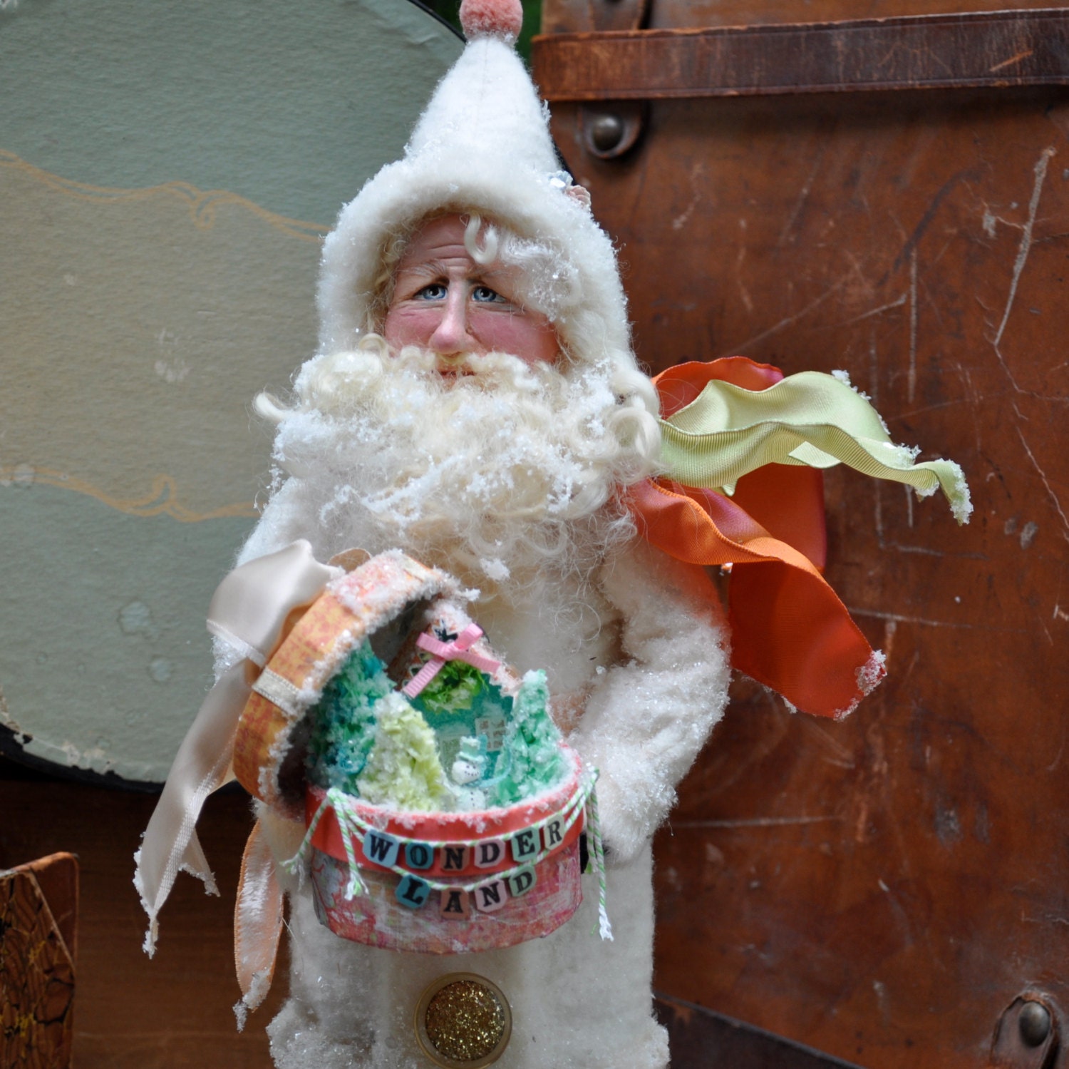 Santa art doll holding a gift box filled with a magical winter scene - one of a kind clay and cloth figure