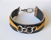 Leather and suede cuff. Hand cut black leather with tan suede. Small size.