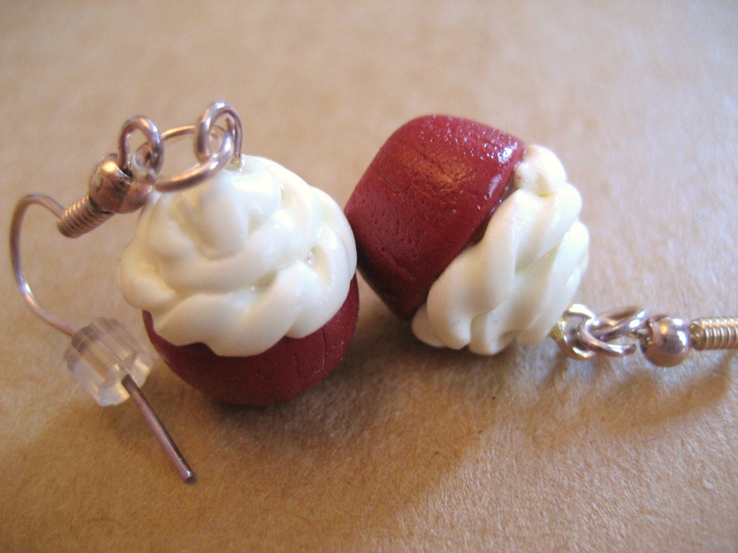 Red velvet cupcake earrings made from polymer clay.