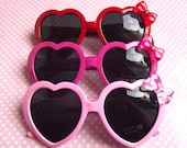 Cute heart shaped sunglasses in hot pink pastel pink and red