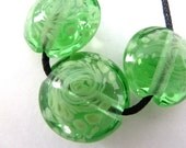 handmade lampwork glass beads, green swirl lentils