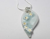 Leaf shaped porcelain pendant, pale green crackle celadon glaze, with white and gold flowers