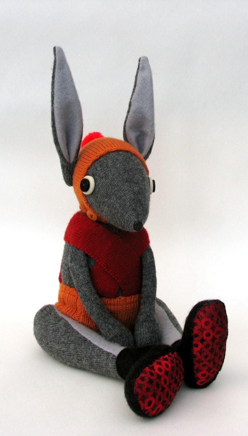 Grey Woollen Rabbit - Handmade plush sculpture - Grey woollen body with felt ears - wearing orange pants with red braces.