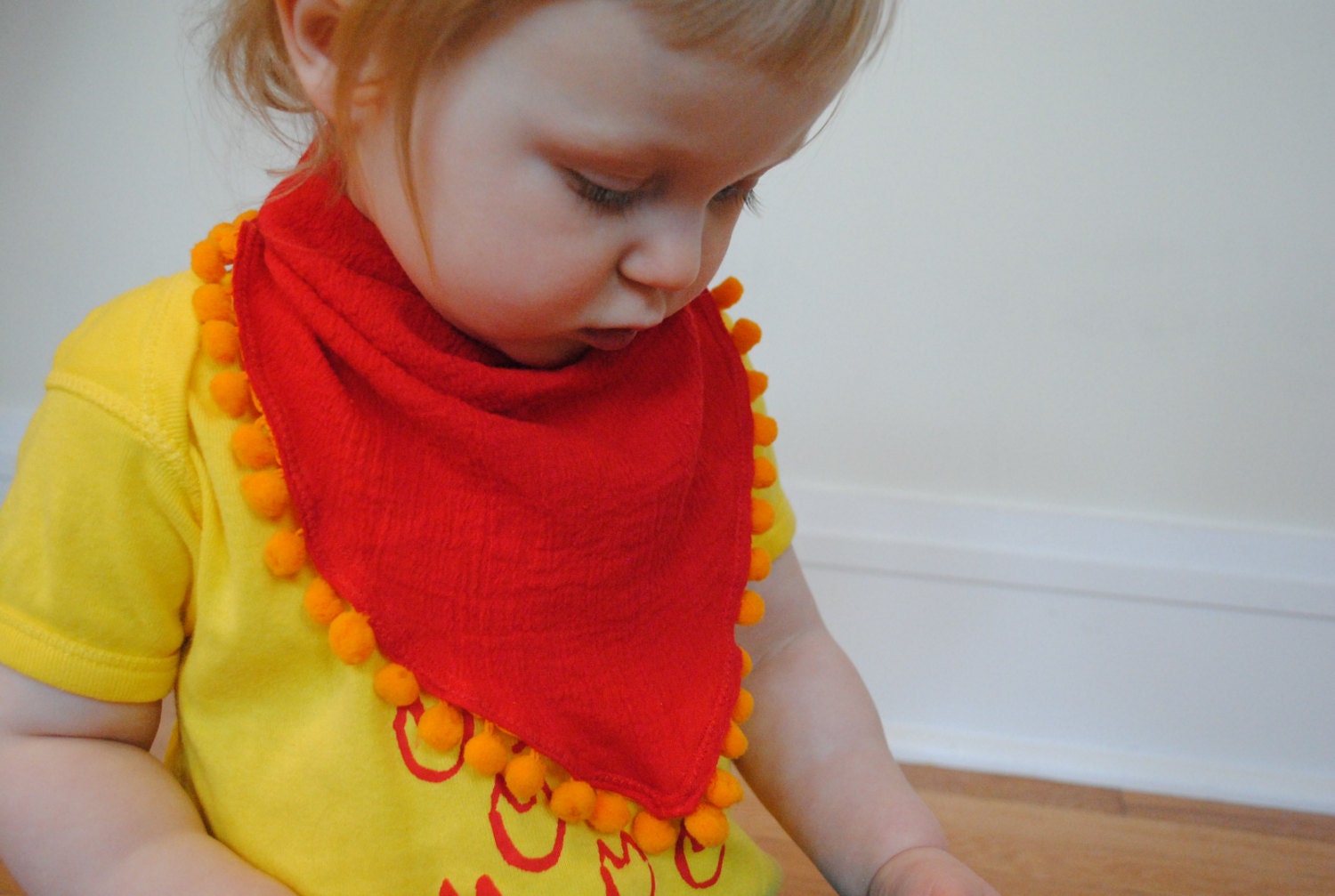 Baby girl bandana, red gauze with orange ball fringe