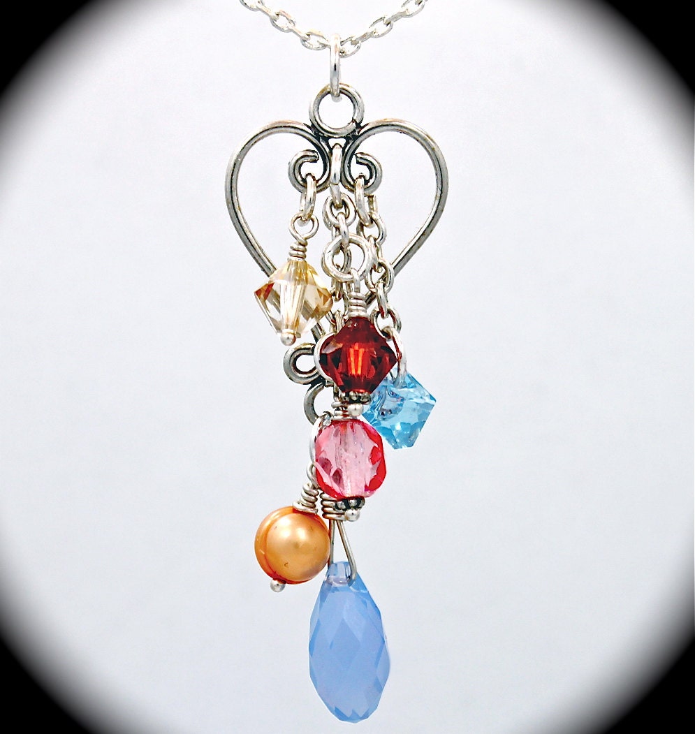 Long sterling heart charm necklace with pearls, Swarovski crystals and sterling charms.