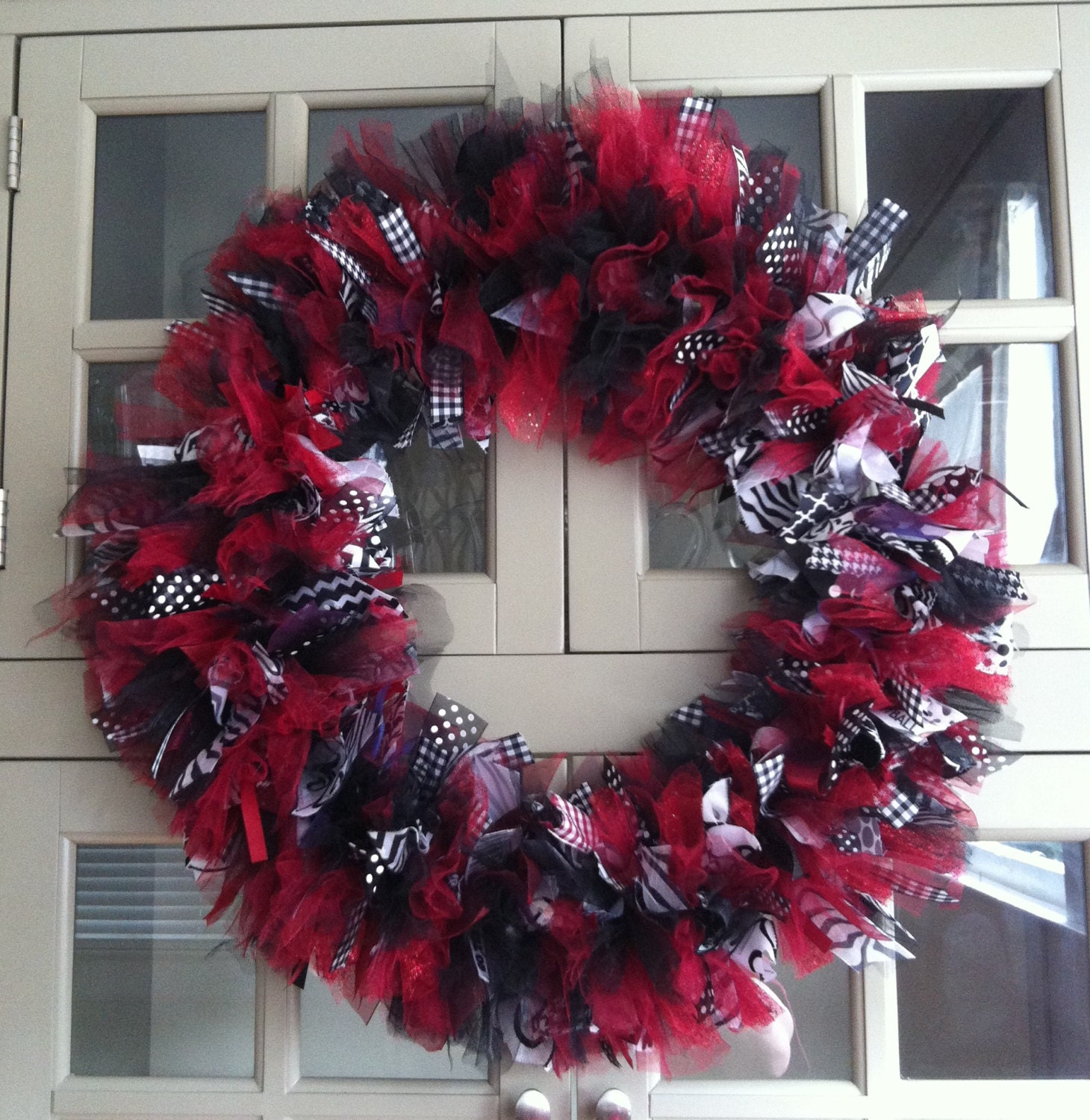 Garnet and Black  Ribbon Wreath on an 18 Inch Base. Finished Wreath is 23 inches Tall and Wide. Tons of ribbon and Tulle lots of Texture...