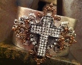 Aged silver metal cuff bracelet with rhinestone cross