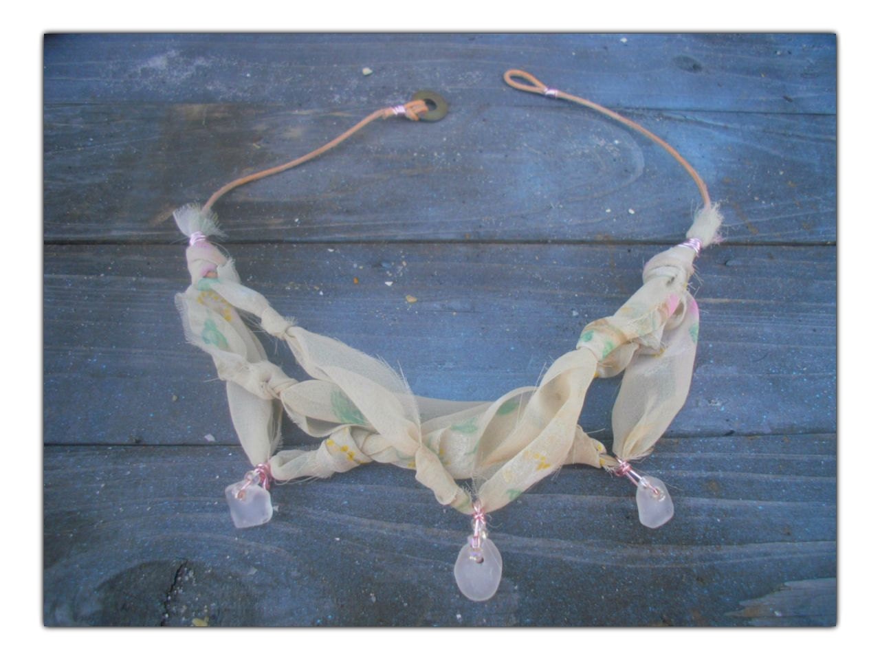 Material Girl - sheer fabric knotted, accented with clear beach glass wrapped in pink wire.