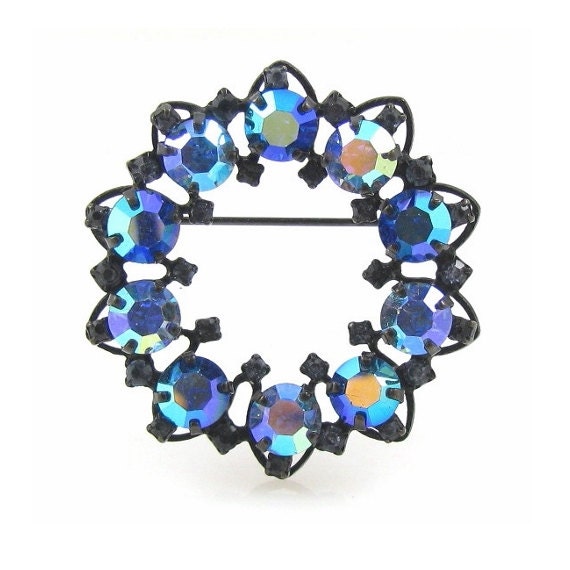 Warner Brooch With Rhinestones In A Japanned Setting