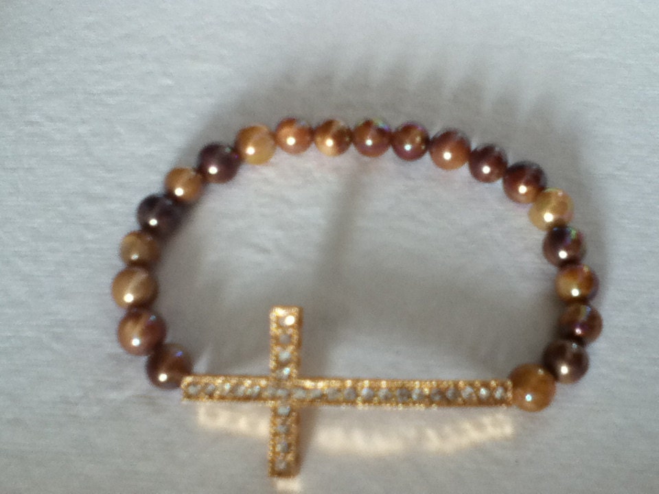 Sideways cross with brown/gold colors beads 