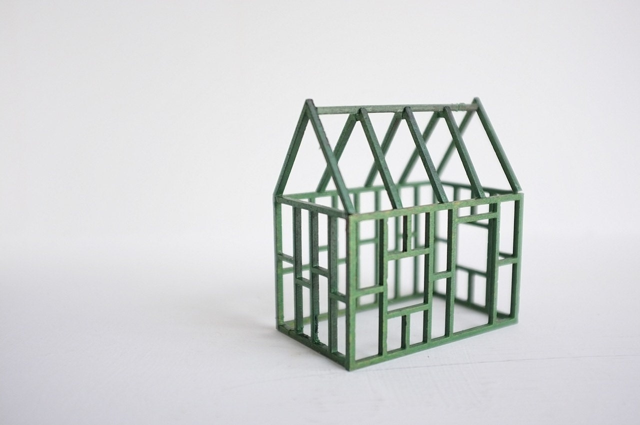 Grass green geometric framework house - miniature architectural structure - spring colors
