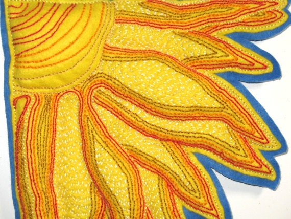 Wall hanging sunburst. Bright yellow felt base with red, orange, yellow, gold and white embroidery stitching. Blue backing. OOAK.