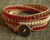 Red Carnelian triple wrap leather beaded bracelet.  Semiprecious gemstone beads, cream and topaz glass beads, brass leaf button.