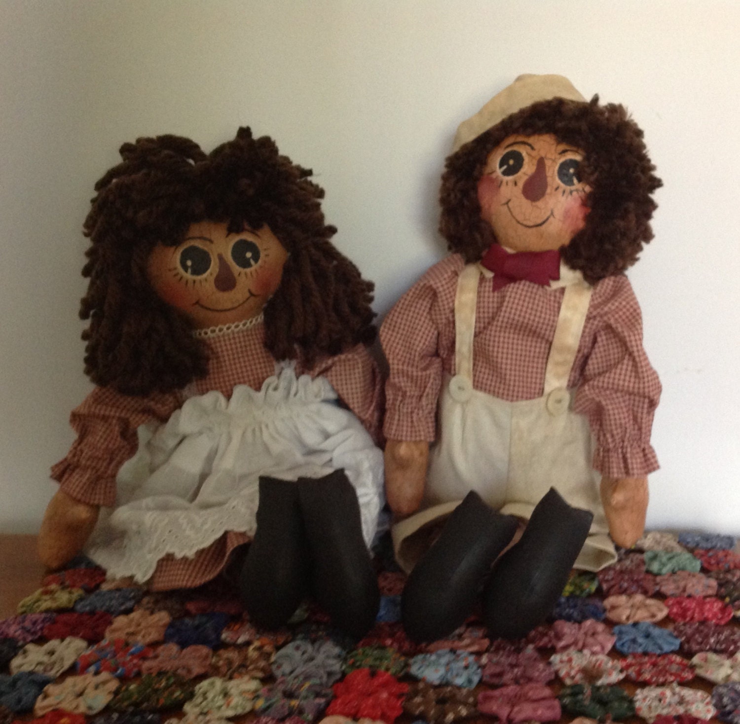 15 inch pair of painted and antiqued fabric Ann and Andy dolls.  Available in brown, burnt orange, or burgundy yarn hair.