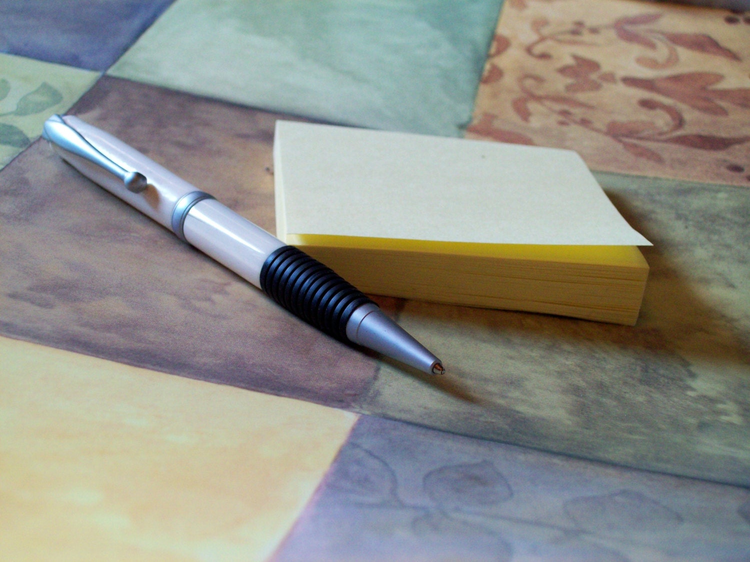 Handmade designer pen featuring Alaskan walrus Ivory, comfort rubber hand grip, and accented with brushed metal
