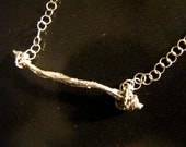 Wooden swing necklace.  Cast silver/gold twig with filigree-wire rope and chain.