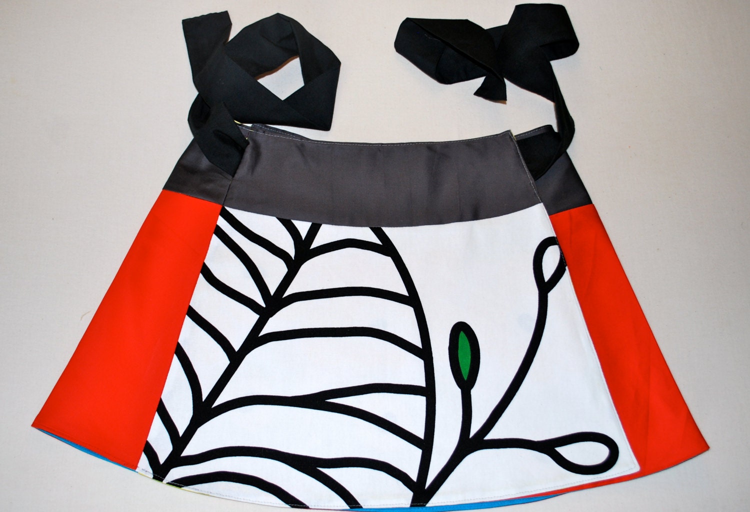 Unique, reversible wrap around mini-skirt, a-line shape, red, grey, black, white, yellow, turquoise blue