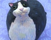 fat Black and white tuxedo cat ceramic sculpture, Tuxedo cat with bluebird on his head, fat black and white tuxedo cat