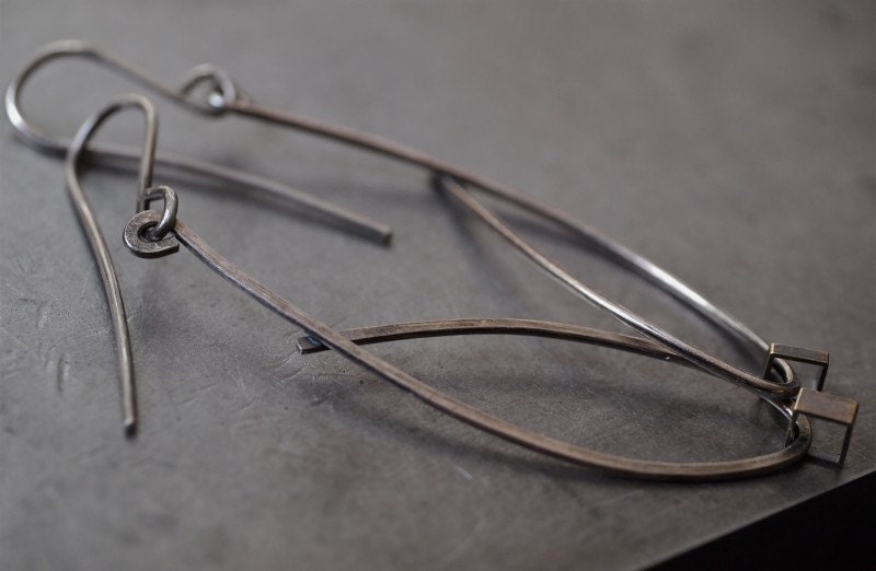 Asymmetrical hammered oval tear drop silver and yellow brass earrings