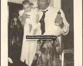 Mr Mom Vintage Photo of a Man Wearing an Apron Holding His Baby and a Bottle