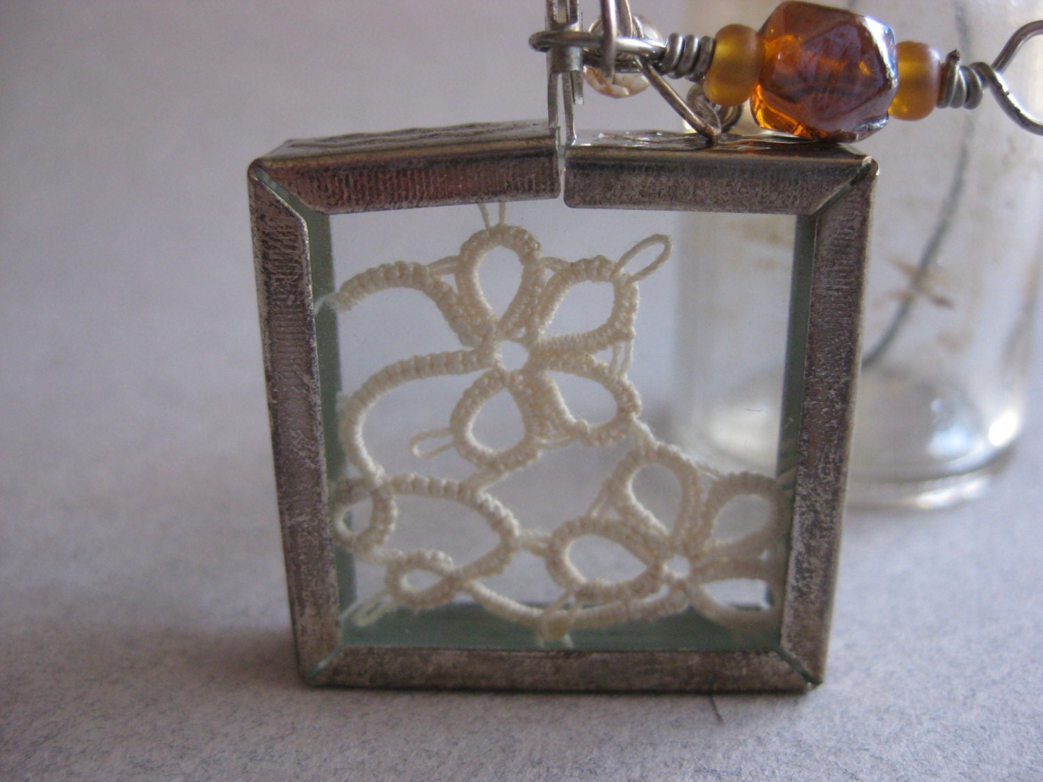 Cream Tatted Motif Between Glass in Silver Frame Pendant