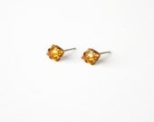 The Topaz Yellow Diamond stud earrings with sterling silver posts