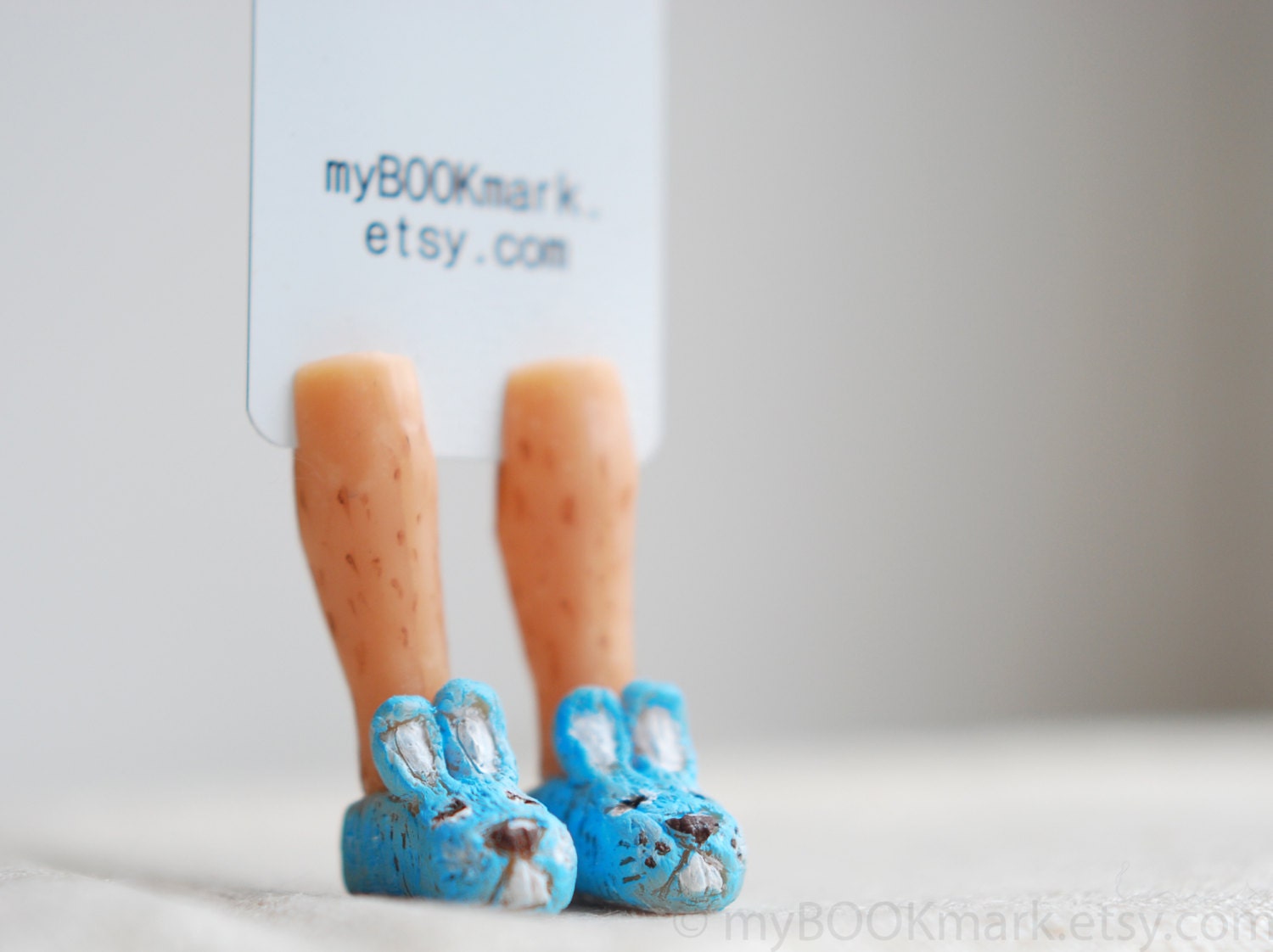 Bunny slippers bookmark. Hairy man legs in the book. Pastel blue rabbit sneakers. Unusual for kids, him, dude, dad. Cute ohtteam