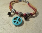 Hippie Charm Bracelet. Turquoise Peace Sign and Brown Pearls. On Burgundy Twine & Orange Organza Ribbon.