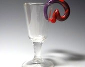 Gauges 2g, polymer clay plugs for stretched lobes. Kick Spiral, cherry red to deep purple.