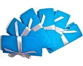 Silk bridesmaid clutches in turquoise with silver satin ribbon. Custom colors available.